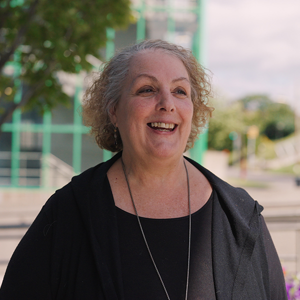 headshot of joanne smiling outside